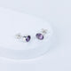 A pair of purple amethyst stud earrings with a faceted cut, displayed against a white background.